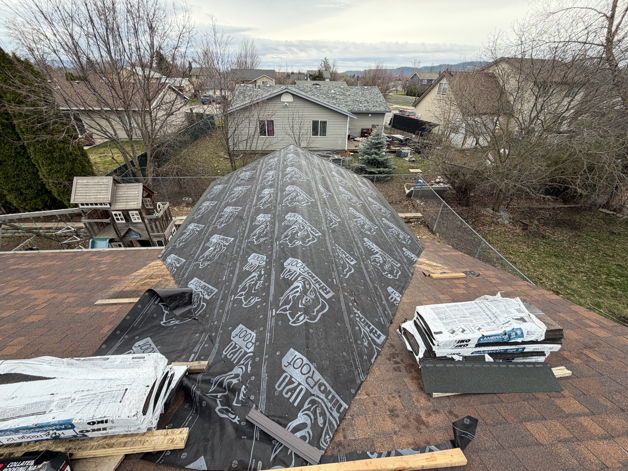 Roof replacement jobsite with materials staged