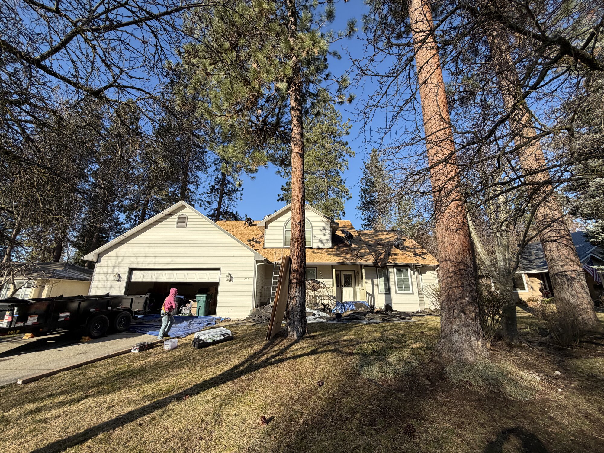 Roofing Rehab crew tearing off an old roof before replacement near Hayden, ID